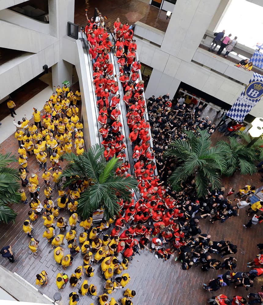 Community members wear the colors of the flag of the Federal Republic of Germany during a celebration the 25th anniversary of the commencement of the dismantling of the Berlin wall, at Miami Dade College in Miami.