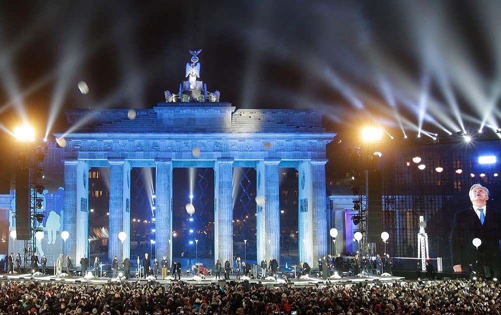 Balloons of the art installation 'Lichtgrenze 2014' fly away in front of Brandenburg Gate during the central event commemorating the fall of the wall in Berlin, Germany.