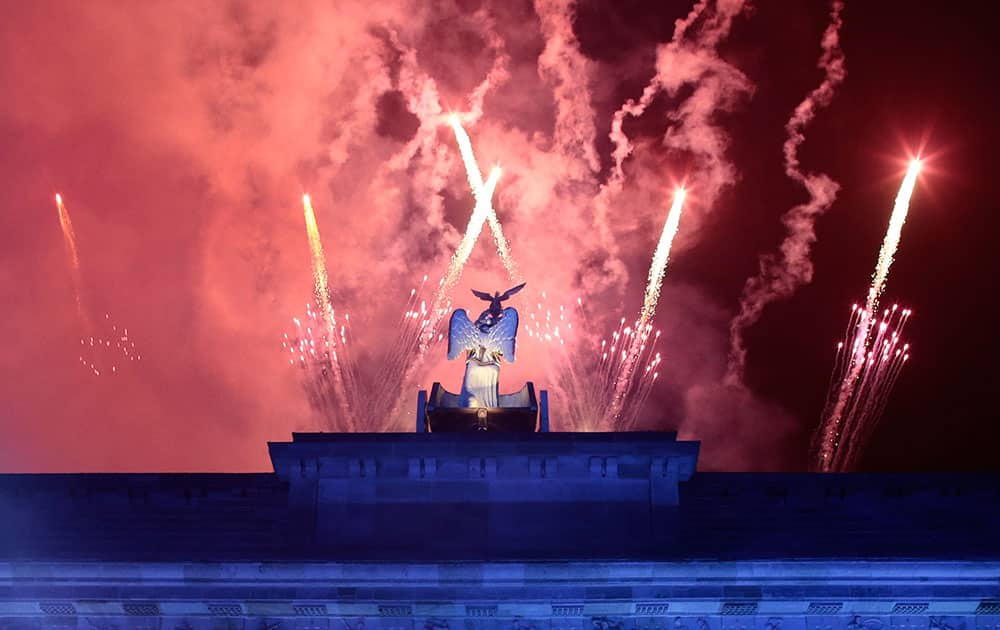 Fireworks explode behind Brandenburg Gate during the central event to commemorate the Fall of the Wall in Berlin, Germany.