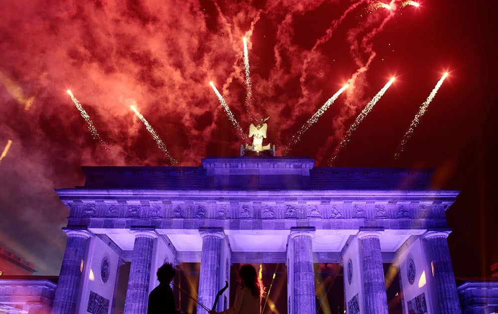 Fireworks explode behind Brandenburg Gate during the central event to commemorate the Fall of the Wall in Berlin, Germany.