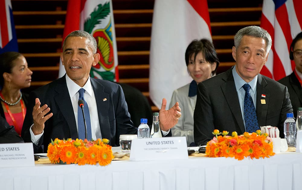 US President Barack Obama, left, speaks as he is seated with Singapore's Prime Minister Lee Hsien Loong, right, during a meeting with leaders of the Trans-Pacific Partnership countries on the sidelines of the APEC summit, in Beijing. 