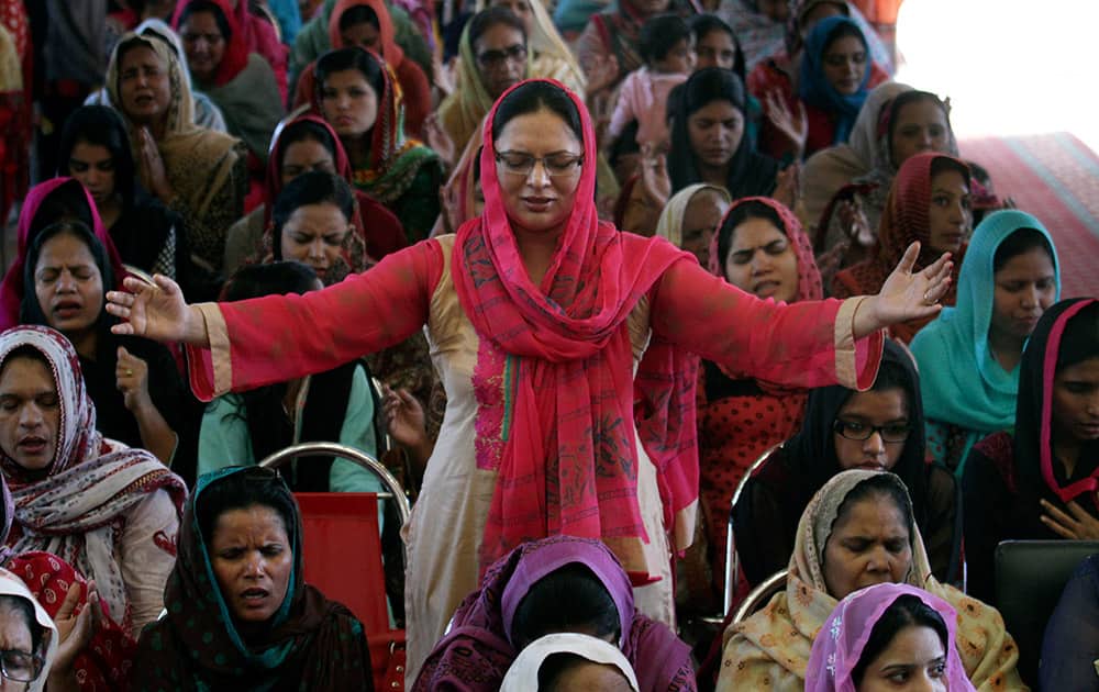 Pakistani Christian women pray for a slain Christian couple, during a service in the Full Gospel Assemblies Church in Lahore, Pakistan. Police in Pakistan said they have arrested as many as 45 Muslims in connection with the killing of the Christian couple for allegedly desecrating the Quran.