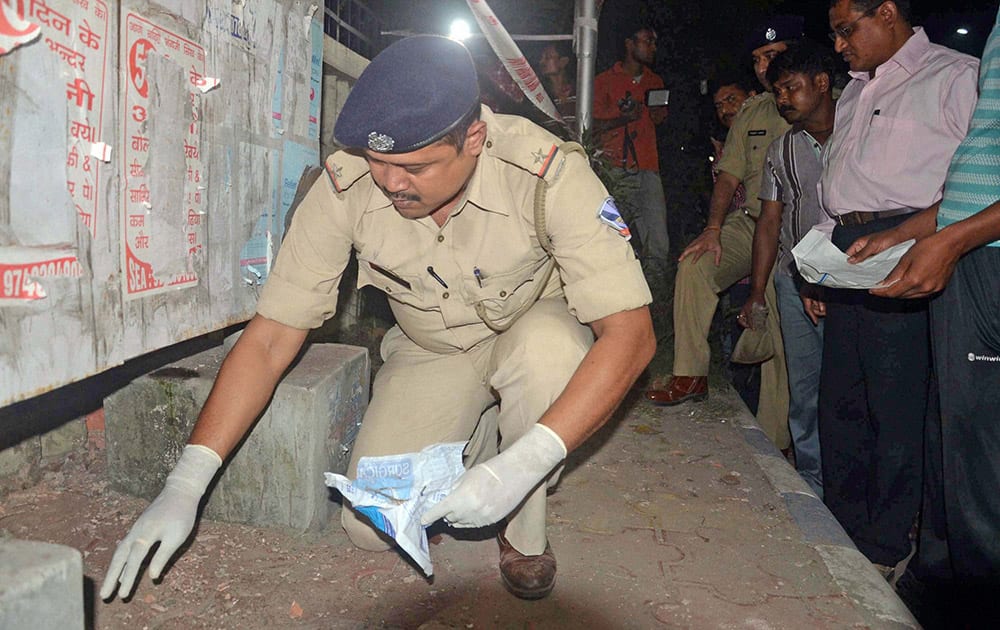 Police officials investigates at the blast side after a powerful explosion outside the Central Reserve Police Force (CRPF) camp, where the National Investigation Agency (NIA) officials probing Bardhaman blast case main accused Sajid Khan is under NIA custody at Salt lake area under North 24 pargana district near Kolkata.
