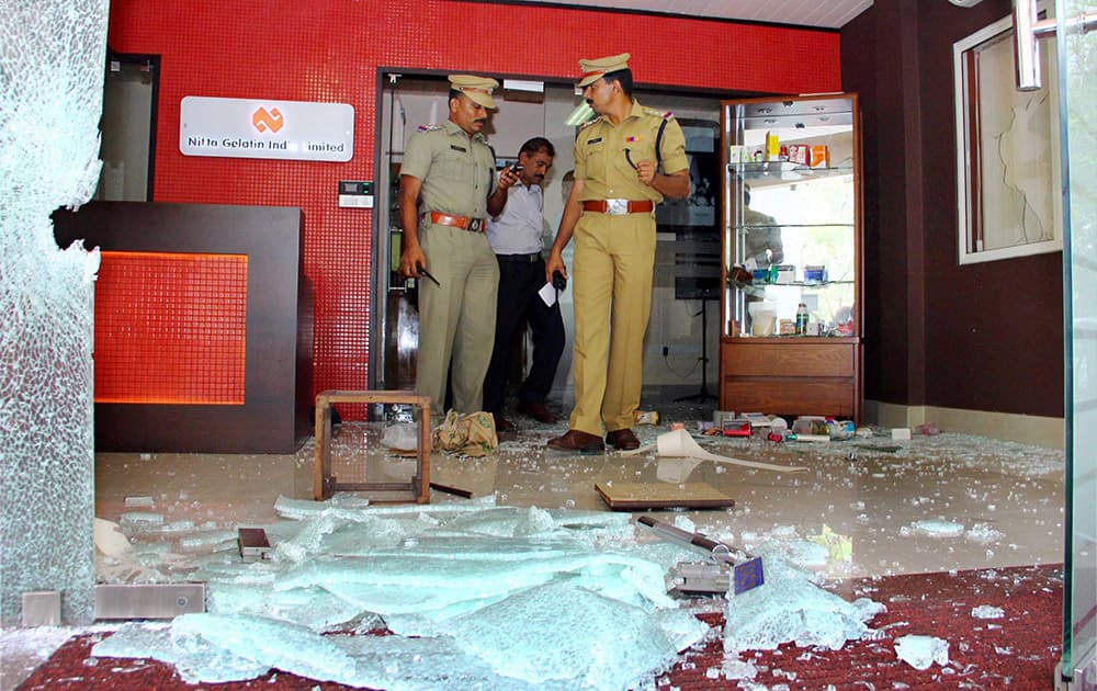 Police officials inspecting the office of Nitta Gelatin India Limited (NGIL), which was attacked in a suspected Maoist attack in Kochi.