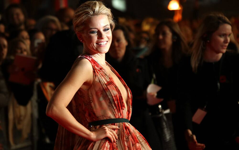 Actress Elizabeth Banks poses for photographers upon arrival to the world premiere of the film The Hunger Games Mockingjay Part 1 in London.