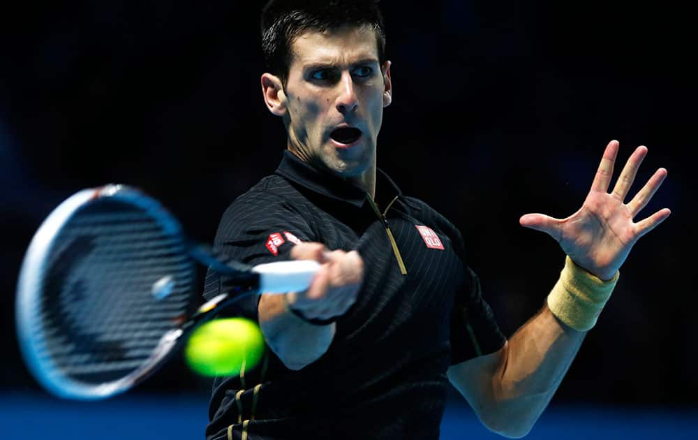 Serbia's Novak Djokovic plays a return against Croatia's Marin Cilic during their singles ATP World Tour tennis finals match at the O2 arena in London.
