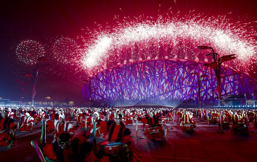 Chinese drum dancers perform as fireworks light up the National Stadium, after a welcome banquet for leaders attend the Asia Pacific Economic Cooperation (APEC) summit in Beijing.