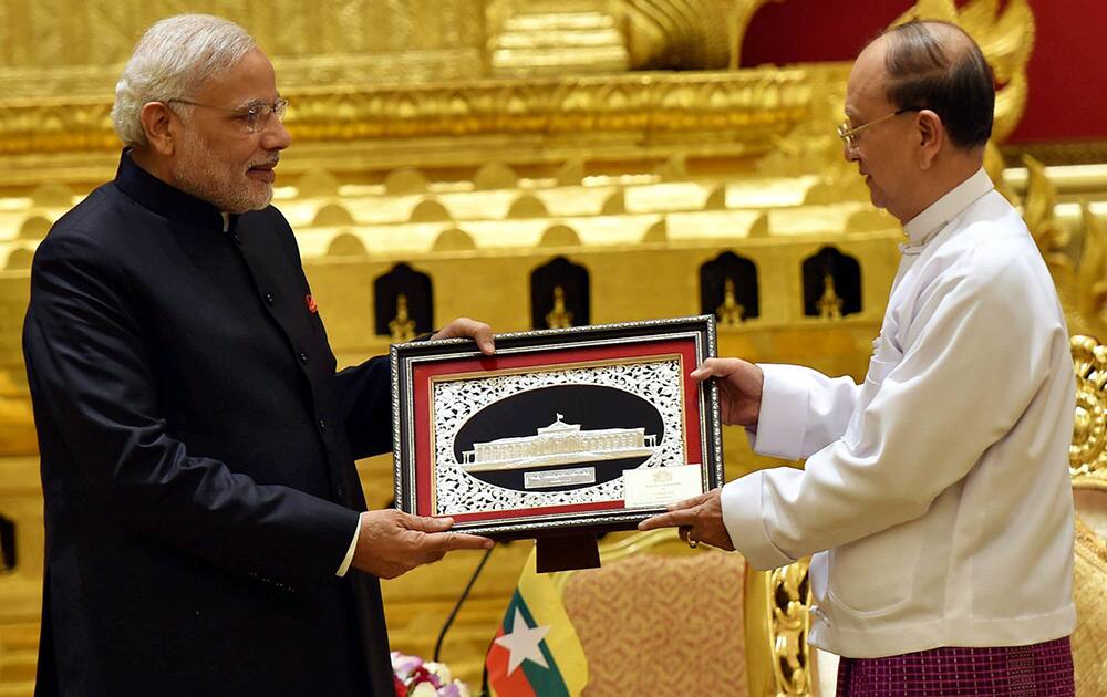 Prime Minister Narendra Modi receives a memento from President of Myanmar, U Thein Sein during a meeting at Presidential Palace in Myanmar.