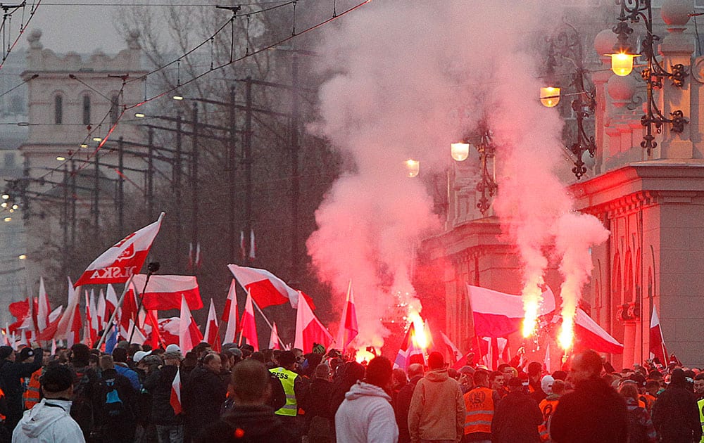 Right wing protesters wave flags at the start of the Independence Day march organized by nationalist parties, in Warsaw, Poland.