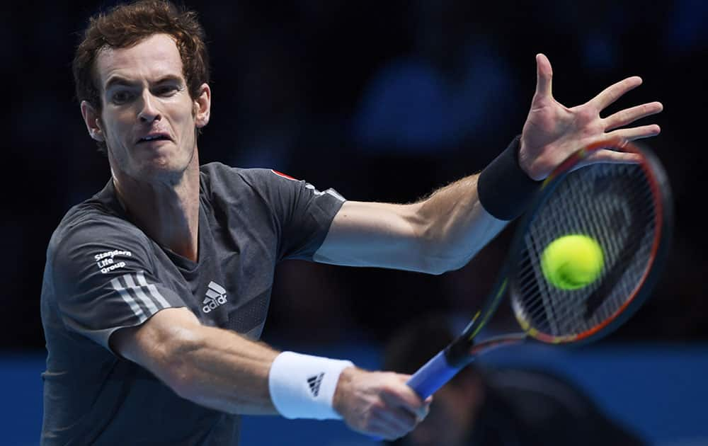 Britain’s Andy Murray plays a return to Canada’s Milos Raonic during their singles ATP World Tour tennis finals match at the O2 arena in London.