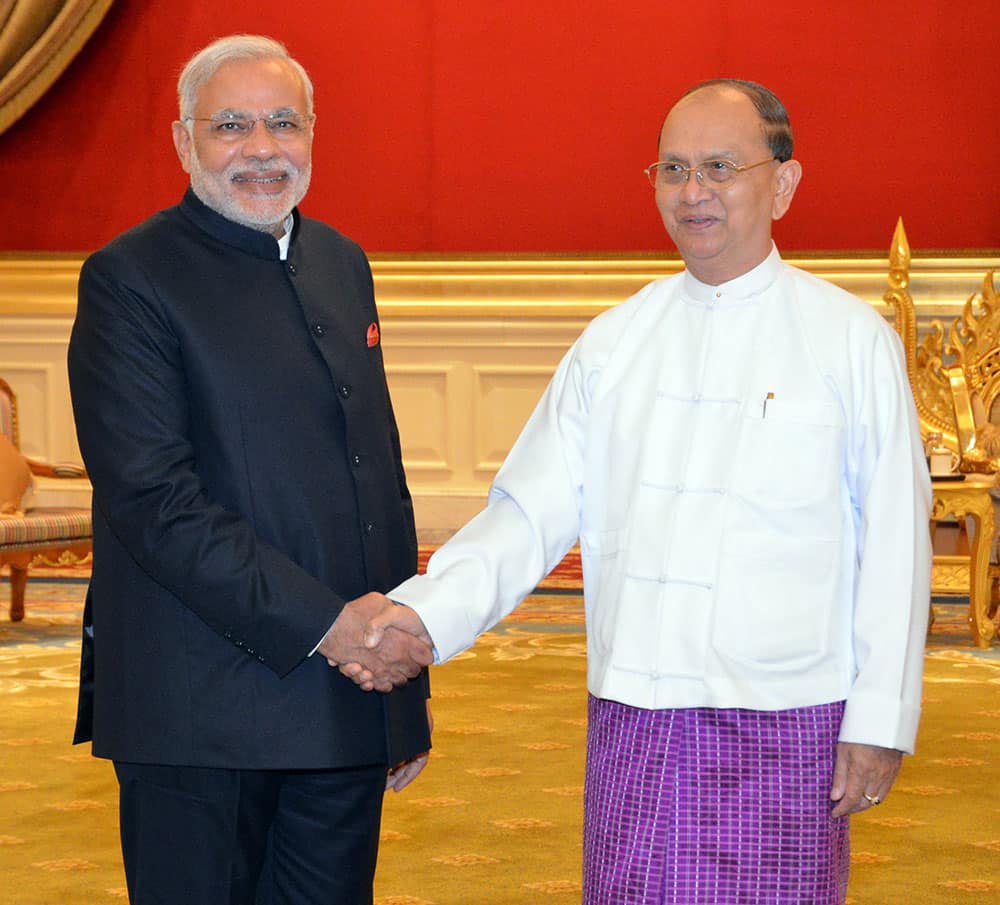 Myanmar President Thein Sein, right, shakes hands with India Prime Minister Narendra Modi, during their meeting at presidential palace in Naypyitaw.