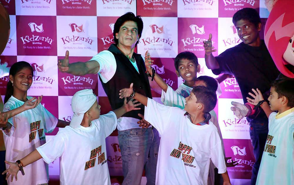 Bollywood actor Shahrukh Khan dances with kids during a Childrens day event in Mumbai.