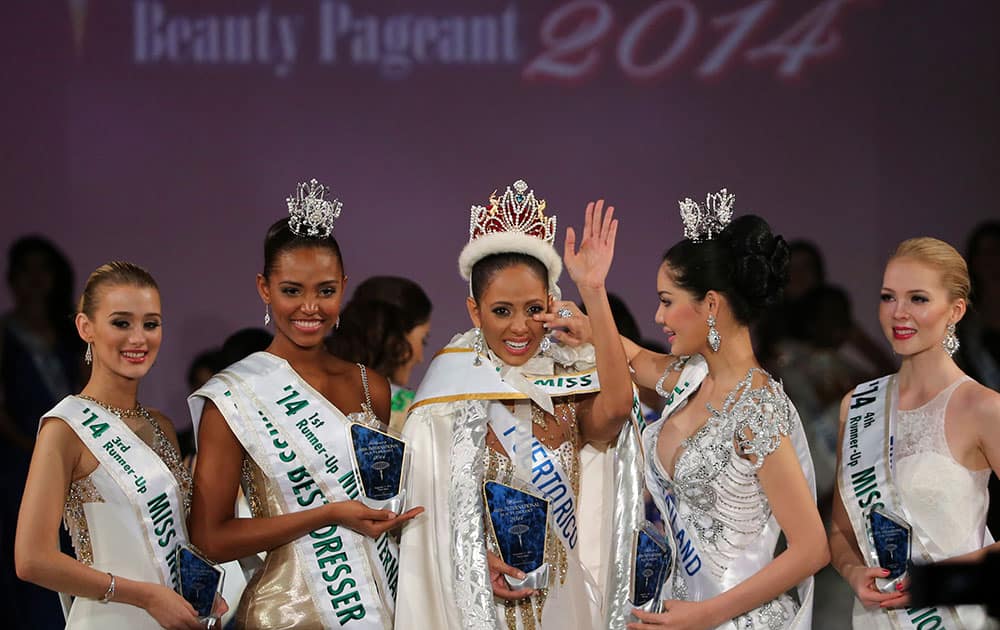 Newly-crowned Miss International Valerie Hernandez Matias, center, of Puerto Rico waves with her runners-up, from left, third runner-up Victoria Charlotte Tooby of Great Britain, first runner-up Zuleika Suarez of Colombia, second runner-up Punika Kulsoontornrut of Thailand and forth runner-up Milla Romppanen of Finland, after the final of Miss International Beauty Pageant in Tokyo.