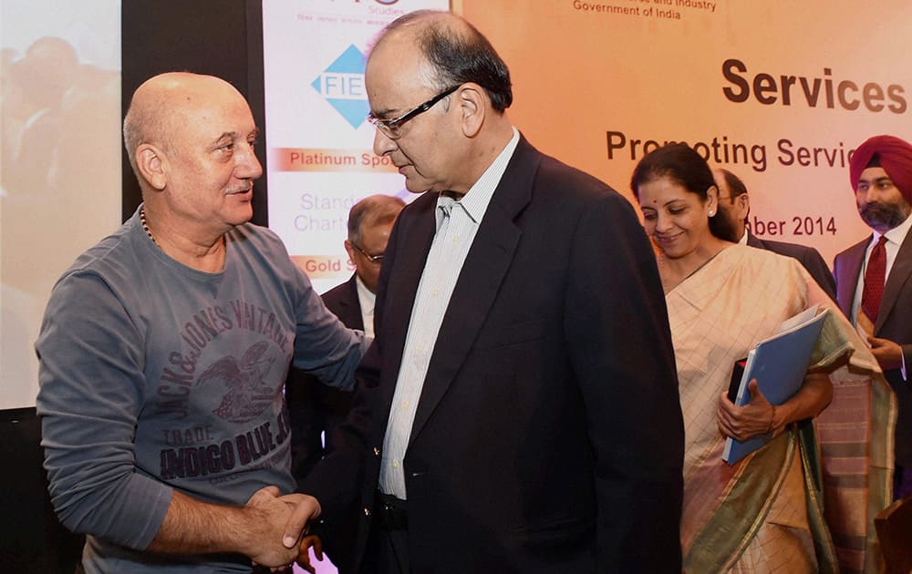 Finance Minister Arun Jaitley with actor Anupam Kher at the opening session of Services Conclave 2014 in New Delhi.