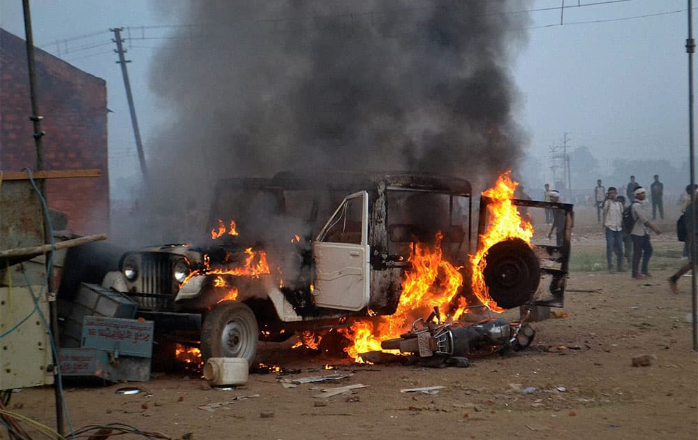 Candidates set ablaze a vehicle after cancellation of an Army recruitment rally in Gwalior.