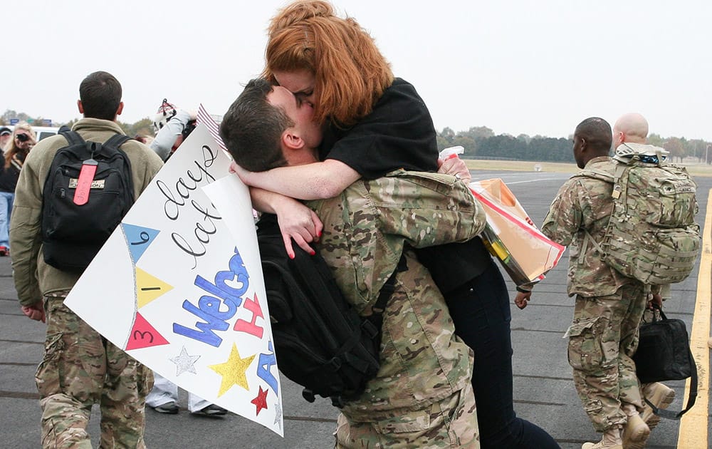 Anthony Taylor kisses his wife, Rebekah, during the homecoming for the U.S. Army Reserve 663rd Horizontal Engineering Company, based in Sheffield, at Signature Aviation in Huntsville, Ala. The unit had been deployed to Afghanistan. 