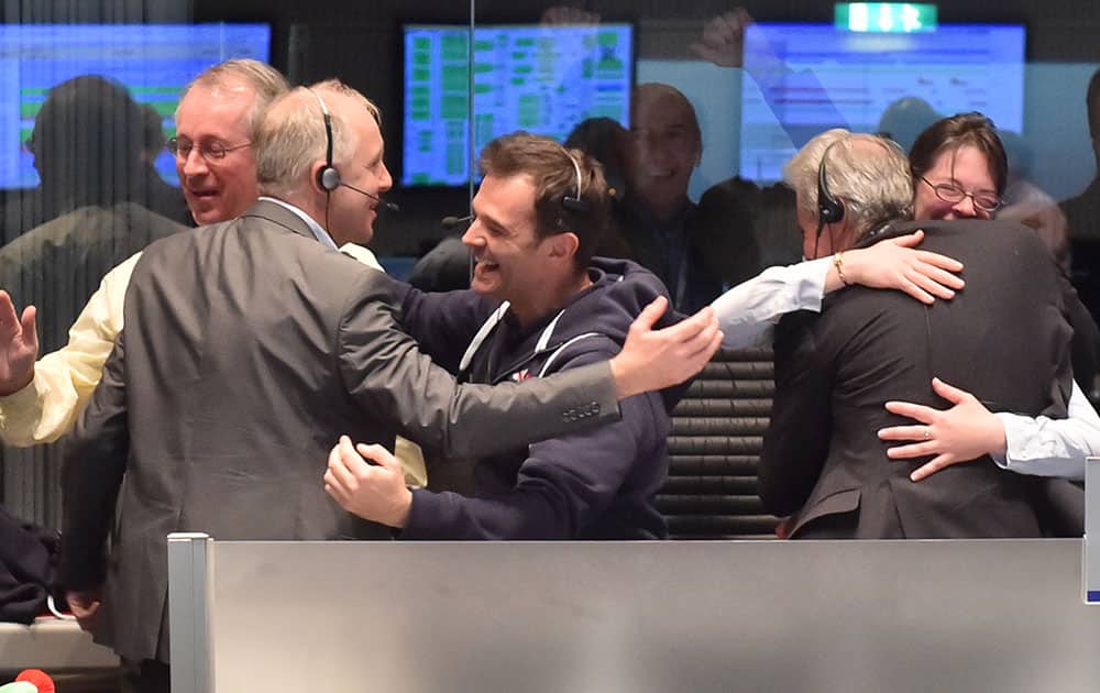 Scientists react in the main control room at the European Space Agency after the first unmanned spacecraft Philae landed on a comet called 67P/Churyumov-Gerasimenko, Darmstadt, Germany.