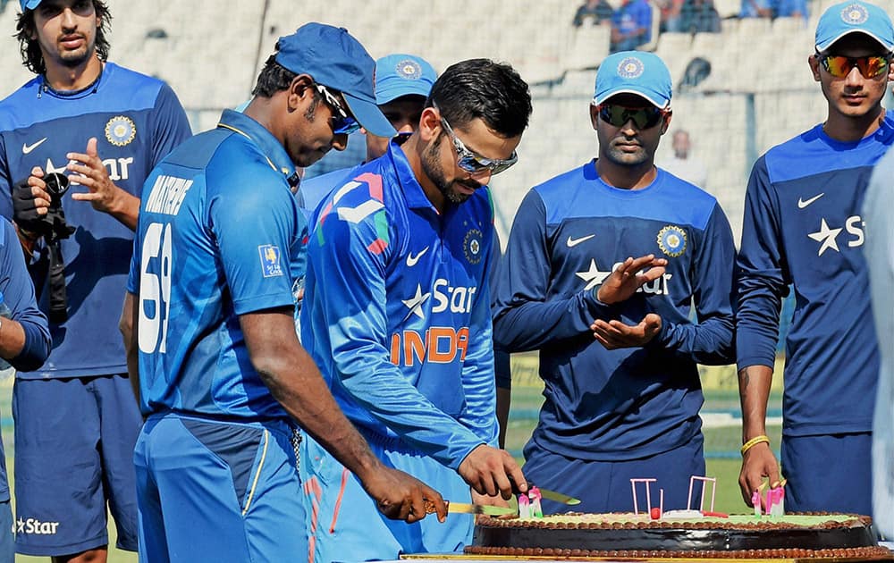 Virat Kohli and Sri Lankan captain Angelo Mathews cutting a cake to celebrate 150 years of Eden Garden, in Kolkata.