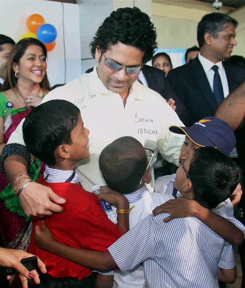 Sachin Tendulkar meets under-privileged and special kids during a event on the eve of Childrens day at Domestic Airport Santacruz in Mumbai.