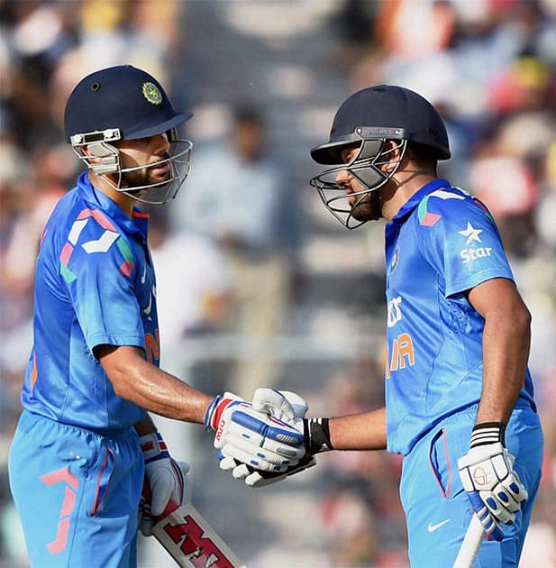 Virat Kohli greets teammate Rohit Sharma after his half century during 4th ODI cricket match against Sri Lanka at Eden Garden.