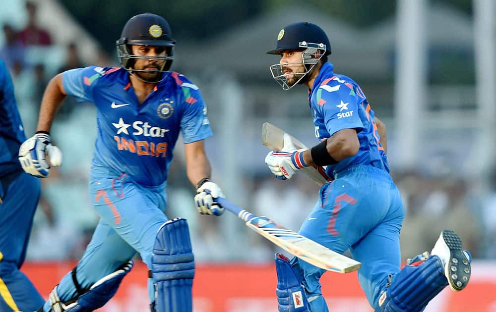 Virat Kohli and teammate Rohit Sharma cross for runs during 4th ODI cricket match against Sri Lanka at Eden Garden in Kolkata.