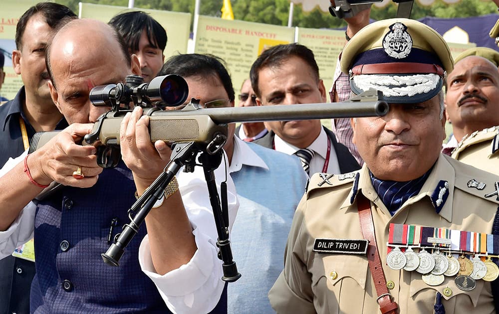Home Minister Rajnath Singh inspects a weapon during Diamond Jubilee celebrations of Central Reserve Police Force (CRPF) at Kadarpur Group Centre in Gurgaon.