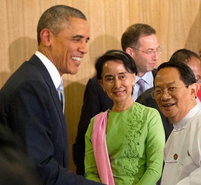 Myanmar's opposition leader Aung San Suu Kyi, looks at U.S. President Barack Obama, greet participants following a meeting at Parliamentary Resource Center, in Naypyitaw, Myanmar..