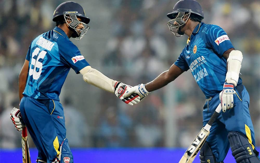 Sri Lankan batsman Lahiru Thirimanue greets his captain Angelo Mathews after he completed his half century during 4th ODI against India at Eden Garden in Kolkata.