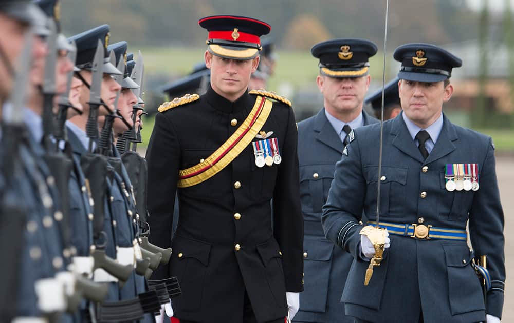 Britain's Prince Harry, Honorary Air Commandant, inspects No 26 squadron RAF Regiment during a presentation of a new standard at Royal Air Force Honington, Bury St Edmunds, England.