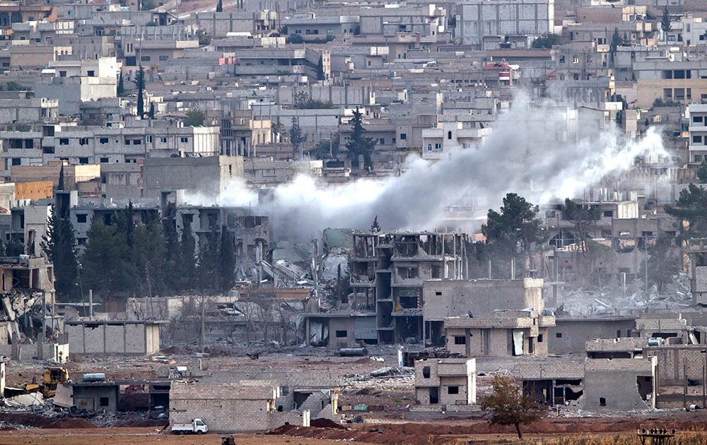 Smoke rises in the Syrian city of Kobani, seen from a hilltop outside Suruc, on the Turkey-Syria border.