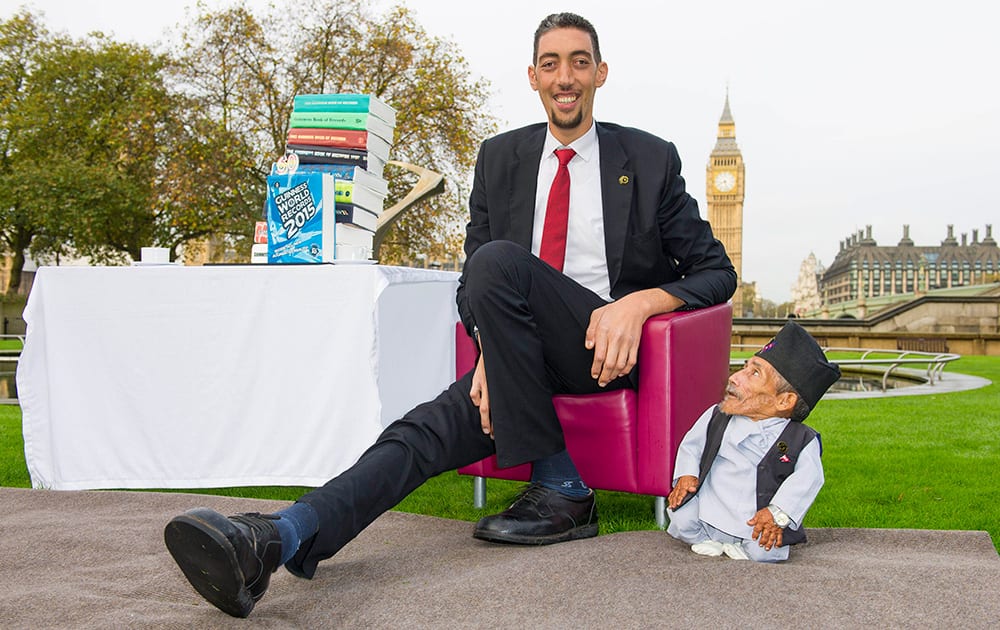 Chandra Dangi, who is 21.5 inches tall, with Sultan Kosen, who is 8 feet 3 inches tall, at a photocall to celebrate the 10th annual Guinness World Records Day in Westminster, London. 