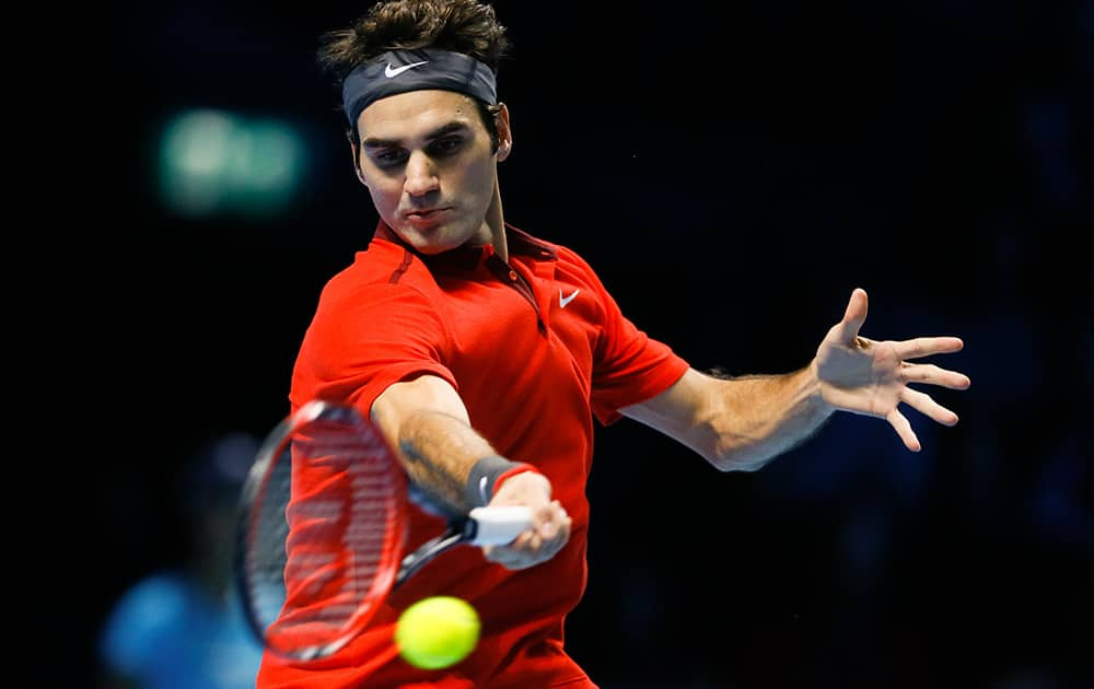 Switzerland’s Roger Federer plays a return to Britain’s Andy Murray during their singles ATP World Tour tennis finals match at the O2 arena in London.