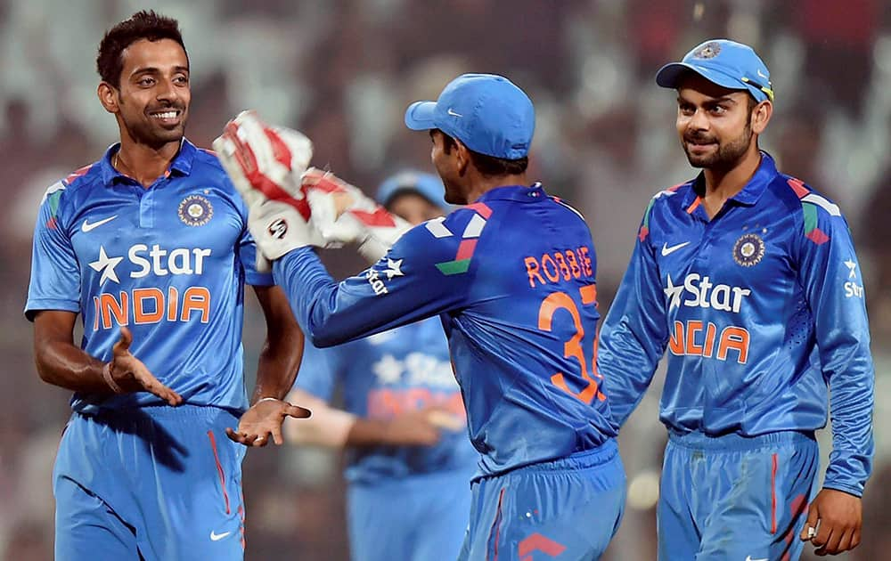 Dhawal Kulkarni jubilates with captain Virat Kohli and teammates after his 4th wicket during 4th ODI match at Eden Garden in Kolkata.