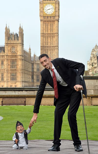 Chandra Dangi, who is 21.5 inches tall, with Sultan Kosen, who is 8 feet 3 inches tall, at a photocall to celebrate the 10th annual Guinness World Records Day in Westminster, London.