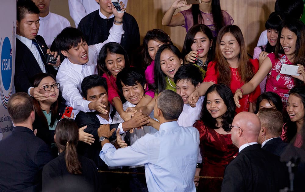 US President Barack Obama shakes hands with the audience after an event with Young South Asian Youth Leaders at Yangon University in Yangon Myanmar.