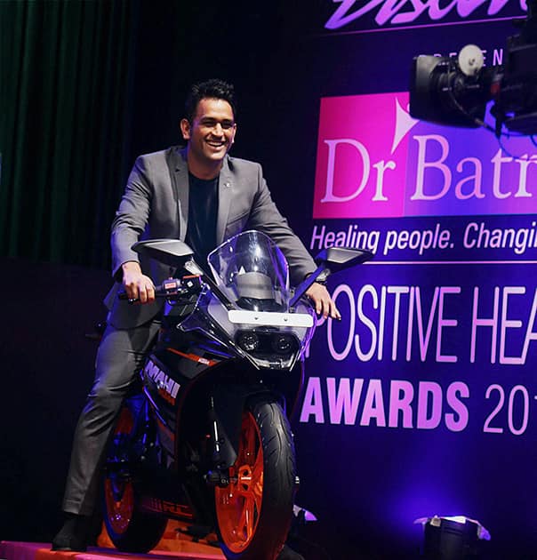 M S Dhoni poses on a bike at the Positive Health Awards function in Mumbai.