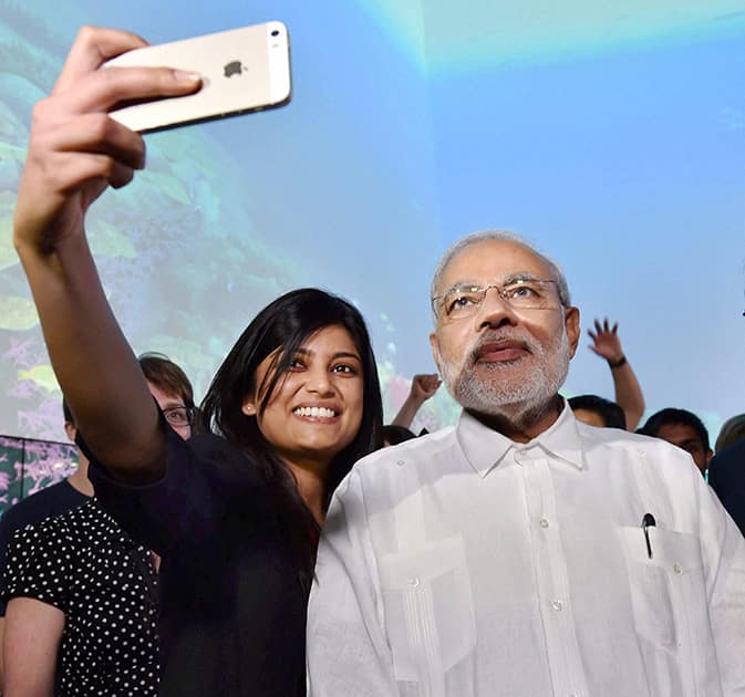Prime Minister Narendra Modi poses for a photo with students during a visit to Queensland University of Technology in Brisbane, Australia.