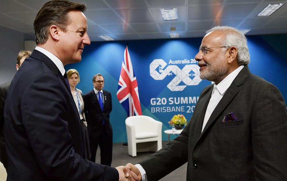 Prime Minister Narendra Modi shakes hands with UK Prime Minister David Cameron during a meeting in Brisbane, Australia.