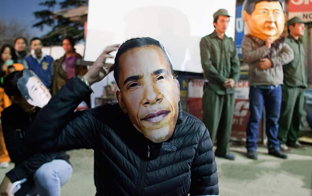 A supporter of Tibet wears a masks of U.S. President Barack Obama during a street demonstration by exile Tibetans asking world leaders attending the G20 summit in Australia to put pressure on China to stop human rights abuse in Tibet, in Dharmsala.