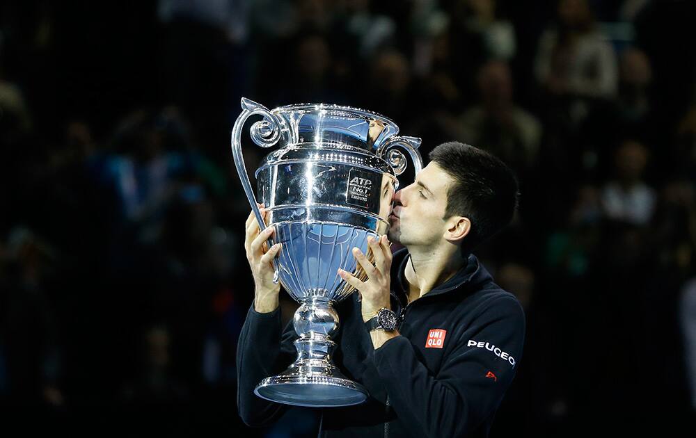 Serbia’s Novak Djokovic kisses the trophy after being ranked World number one, after the singles ATP World Tour Finals tennis match against Czech Republic’s Tomas Berdych, at the O2 Arena in London.