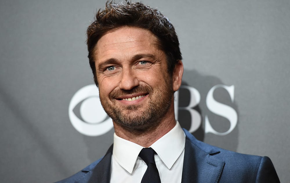 Gerard Butler poses in the press room with the Hollywood animation award for 