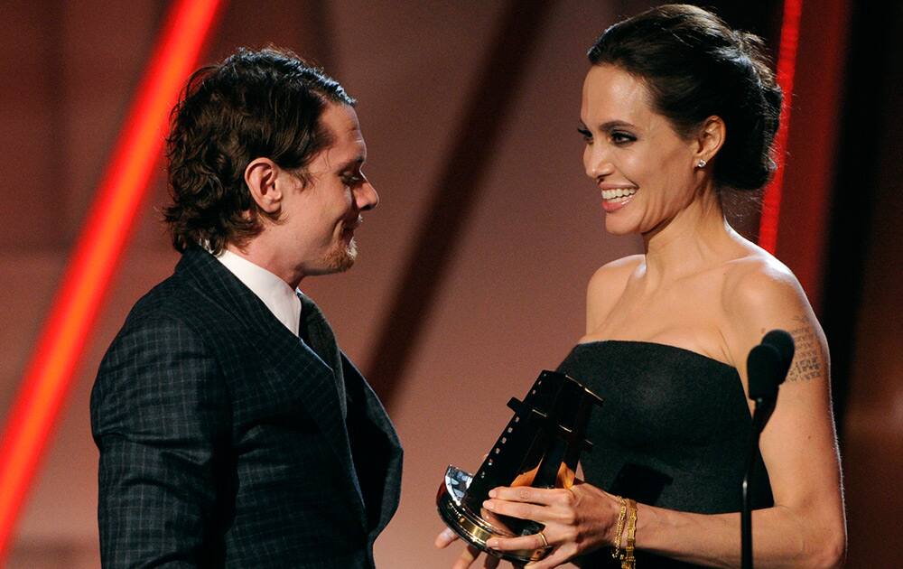 Angelina Jolie presents the new Hollywood award to Jack O'Connell at the Hollywood Film Awards at the Palladium in Los Angeles. 