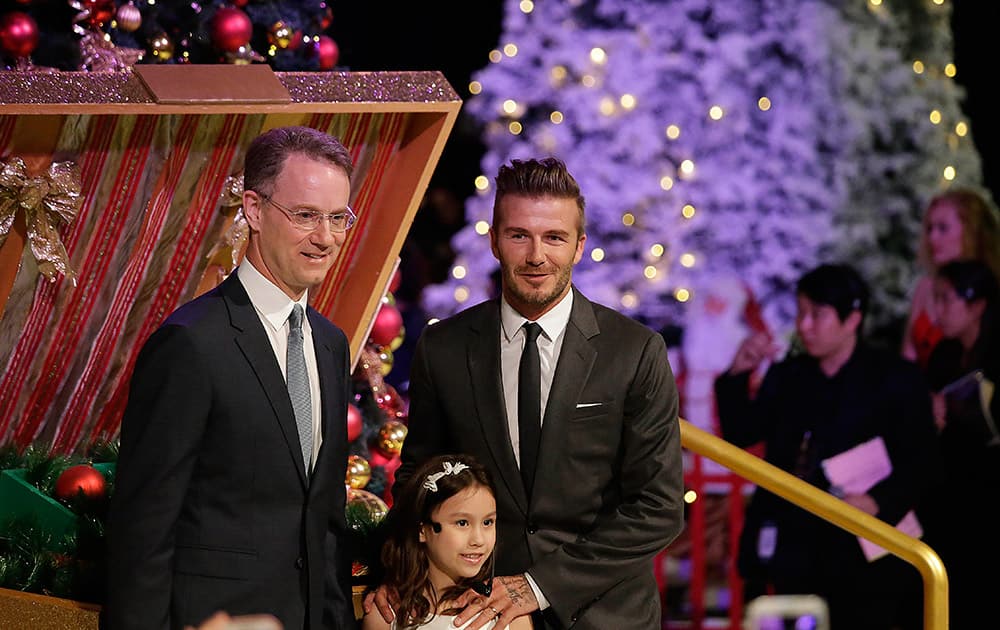 Former England soccer captain David Beckham, is accompanied by Marina Bay Sands President and Chief Executive Officer George Tanasijevich, attends a Christmas tree lighting at the Marina Bay Sands Casino Resorts, in Singapore.