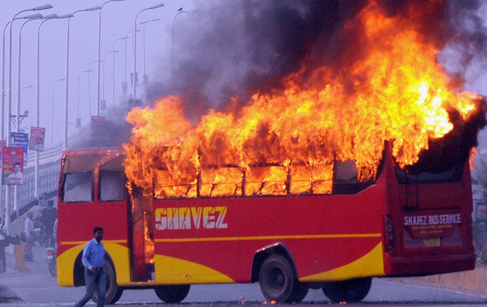 Protesters set a bus on fire after the killing of two persons in an accident in Lucknow.