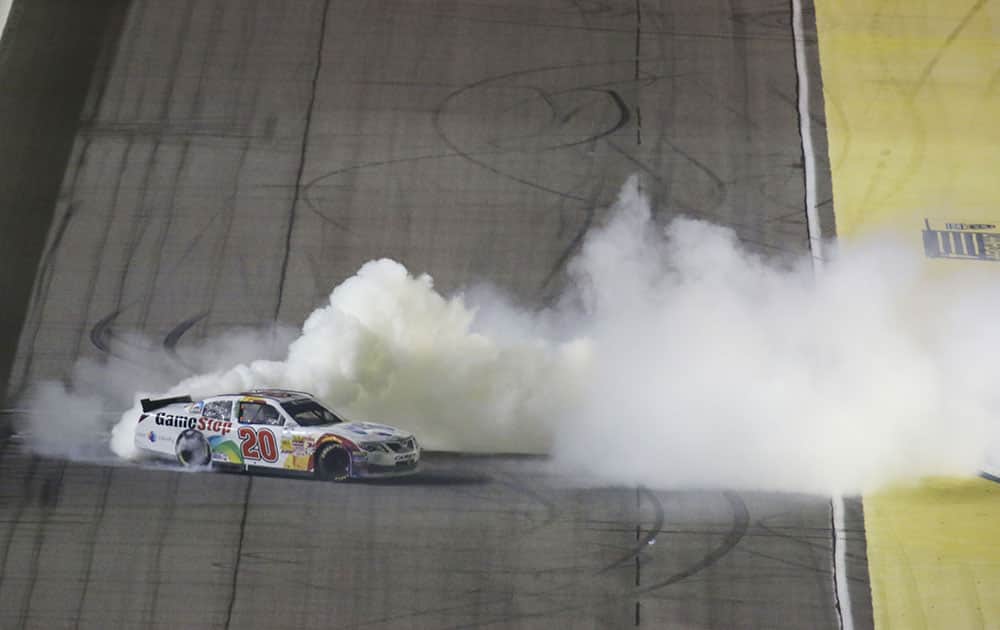 Matt Kenseth does a burn out after winning the NASCAR Nationwide series championship auto race, in Homestead, Fla. 
