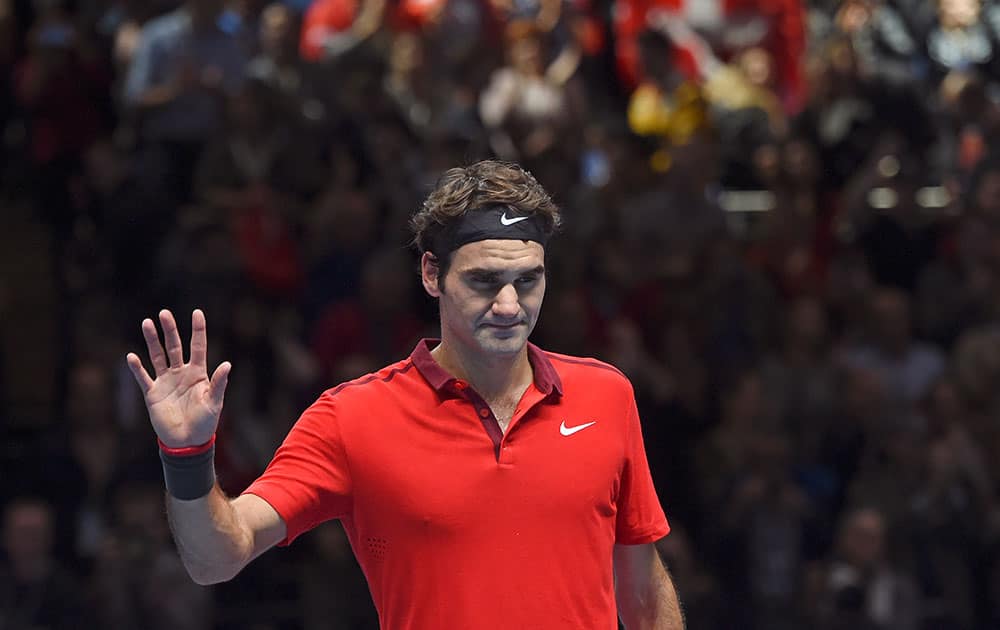 Switzerland’s Roger Federer celebrates winning his ATP World Tour Finals semifinal tennis match against his compatriot Stan Wawrinka at the O2 Arena in London.