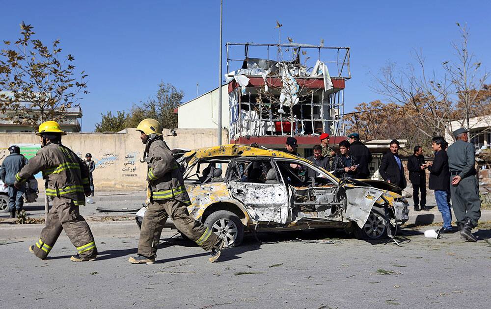 Afghan security forces and emergency personnel work at the site of a suicide attack in Kabul, Afghanistan. A suicide bomber tried to assassinate Shukria Barakzai, a prominent female member of Afghanistan's parliament on Sunday, killing several people and wounding the lawmaker, a senior official said. 