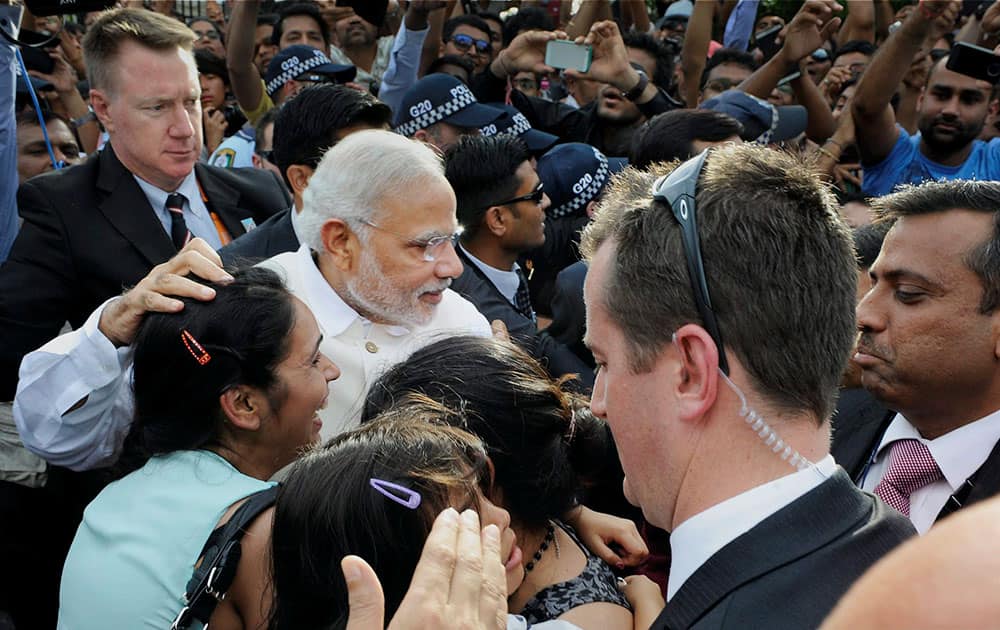 Prime Minister Narendra Modi is thronged by the supporters as he arrives to unveil the statue of Mahatma Gandhi at Roma Street in Brisbane, Australia.