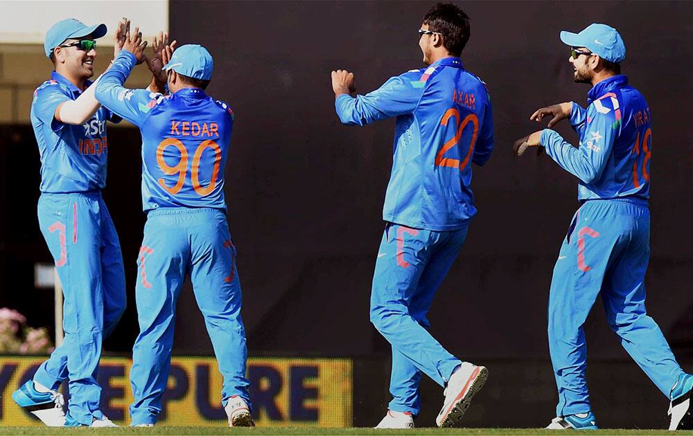 Indian cricketers celebrate the dismissal of a Sri Lankan batsman during 5th ODI cricket match in Ranchi.