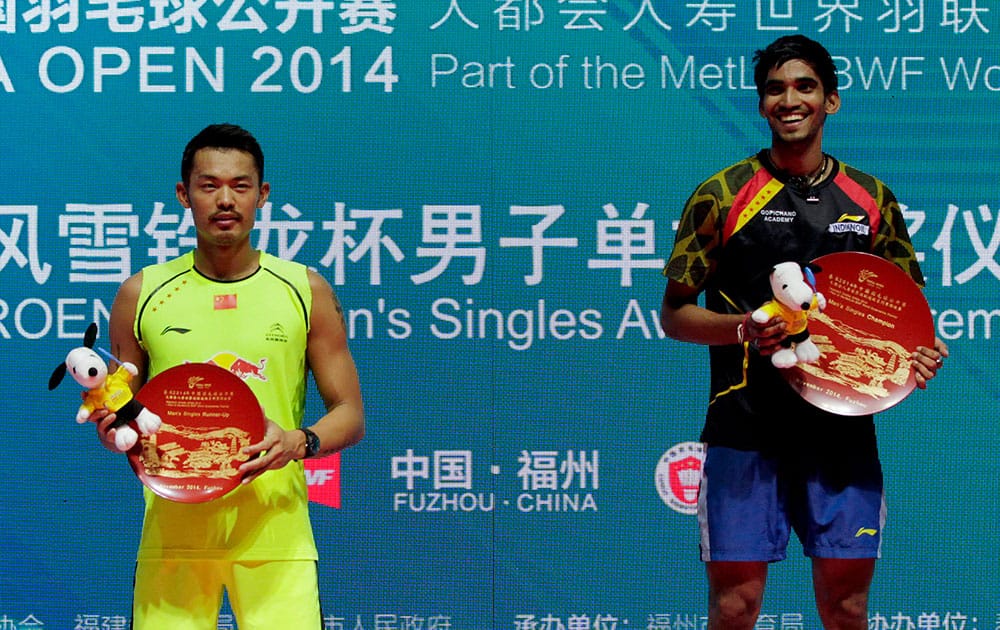 India's Kidambi Srikanth, right, with his trophy stands next to Lin Dan of China on podium after the men's singles final in China Open Badminton in Fuzhou.